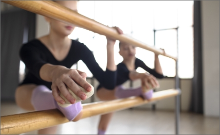 Girl with leg over bar